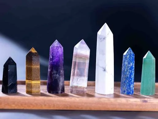 A spectrum of natural crystal points, from violet and green to clear and golden tones